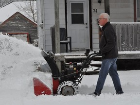 Rod Simpson, like many other Cornwall residents, cleared out his driveway following Saturday's snowstorm. Francis Racine/Cornwall Standard-Freeholder/Postmedia Network