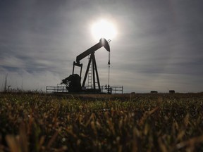 A pumpjack works at a well head on an oil and gas installation near Cremona, Alberta.