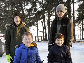 The Dietrich brothers - Jacob (left), Owen, Dylan and Brandon - pose with their latest extracurricular project, a "snow bicycle" they created on their Bornholm-area home farm. ANDY BADER/MITCHELL ADVOCATE