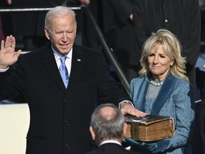 Joe Biden is sworn in as the 46th president of the United States by Chief Justice John Roberts as Jill Biden holds the Bible during the 59th Presidential Inauguration at the U.S. Capitol in Washington on Jan. 20, 2021. (Saul Loeb/Pool Photo via AP)