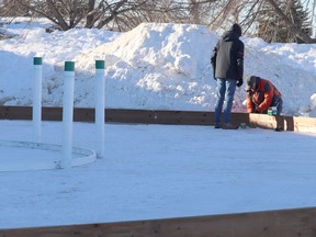Town employees build a Crokicurl rink by the Community Centre. Jackie Irwin/Postmedia