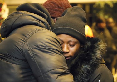 Uche Osagie, right, is comforted by a community member during a candlelight vigil in Sudbury, Ont. on Thursday January 16, 2020, in memory of her three children who died in a collision on New Year's Day. The ceremony was held at Tom Davies Square to commemorate the lives of Destiny, Flourish and Britney Osagie. Osagie was later charged. John Lappa/Sudbury Star/Postmedia Network