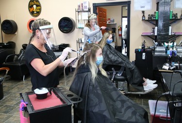 Lisa Comisso, left, adds highlights to Melissa Belanger's hair, while Danielle Cote styles Abby Redmond's hair at Hair Central Sudbury on Durham Street in Sudbury, Ont. on Friday June 12, 2020. Local barber shops, hair salons and hairdressers/stylists were allowed to open as part of the Ontario government's Stage 2 reopening plan. John Lappa/Sudbury Star/Postmedia Network