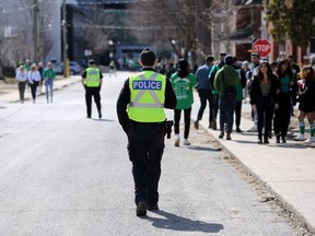 Kingston Police officers work to keep the University District streets clear during St. Patrick's Day 2020.