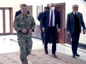 U.S. envoy for peace in Afghanistan Zalmay Khalilzad, centre, U.S. Army Gen. Resolute Support Mission and United States Forces, left, and Abdullah Abdullah, chairman of the High Council for National Reconciliation, arrive for a meeting in Kabul, Afghanistan, on Jan. 5.