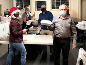 Getting turkey dinners ready to go, Jayne Curtis and Brian Brooks (rear), Pam Shea and Paul Scott helped prepare and package just over 140 meals with all the fixings to be delivered in Gananoque by the Lions Club on December 11.  
Supplied by David Charles