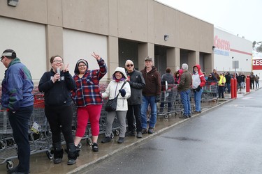 A line forms at the entrance to Costco in Sudbury, Ont. on Tuesday March 17, 2020, as people wait for the store to open. John Lappa/Sudbury Star/Postmedia Network