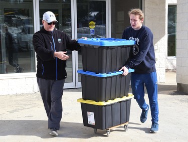 Laurentian University student Cameron McCabe, right, and his dad, Jamie, prepare to load Cameron's belongings into a truck at the campus in Sudbury, Ont. on Thursday March 19, 2020. Classes at Ontario postsecondary institutions ended abruptly due to the COVID-19 pandemic. John Lappa/Sudbury Star/Postmedia Network