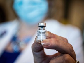TOPSHOT - A healthcare worker holds a Pfizer-BioNtech Covid-19 vaccine at Memorial Healthcare System, in Miramar, Florida on December 14, 2020. - The United States kicked off a mass vaccination drive Monday hoping to turn the tide on the world's biggest coronavirus outbreak, as the country's death toll neared a staggering 300,000. (Photo by CHANDAN KHANNA / AFP) (Photo by CHANDAN KHANNA/AFP via Getty Images)
