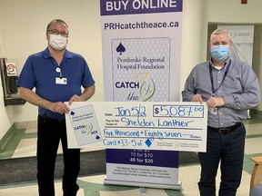 Pembroke Regional Hospital Foundation Catch the Ace progressive jackpot raffle week #25 winner Sheldon Lanthier is presented with his winnings amounting to $5,087 by Foundation Executive Director Roger Martin. Submitted photo