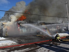 Firefighters battle a blaze at Art-E-Motive Repairs on Petawawa Blvd. on the afternoon of Jan. 28.
