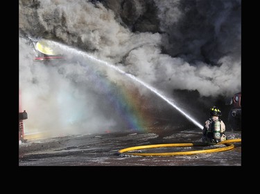 Firefighters battle to extinguish the blaze that consumed Art-E-Motive Repairs on Petawawa Blvd. on the afternoon of Jan. 28.