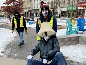 Lights On Stratford crew members Hilary Nichol and Alex Maitland were dismantling exhibits from the winter festival of lights Wednesday at Market Square. Organizers pulled the plug after new provincial restrictions were announced this week. (Cory Smith/The Beacon Herald)