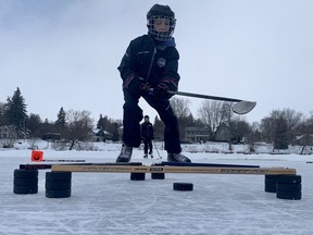 Maddyx Chaput, foreground, and his twin brother Hudson, 11, worked on some hockey drills on the Avon River Thursday afternoon. (Cory Smith/The Beacon Herald)