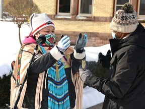 Winona Sands, a member of the Chippewa Nation of Walpole Island, performs a smudging ceremony in January with Dr. Gezaghn Wordofa, founder of the Multicultural Association of Perth-Huron, during the association's weekly inclusivity and anti-racism rallies in front of the Perth County Courthouse. (Galen Simmons/Beacon Herald file photo)