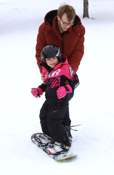 Joseph Bouchard helps his daughter, Paislee May Collin, 5, snowboard at Bell Park in Sudbury, Ont. on Monday January 4, 2021. John Lappa/Sudbury Star/Postmedia Network