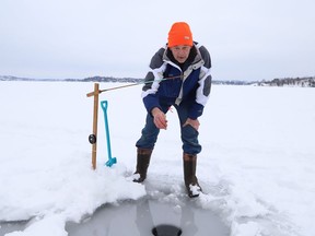 John Hickey tries his luck at ice fishing on Ramsey Lake in Sudbury, Ont. on Tuesday January 5, 2021.