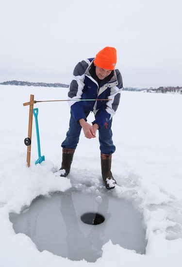 John Hickey tries his luck at ice fishing on Ramsey Lake in Sudbury, Ont. on Tuesday January 5, 2021. John Lappa/Sudbury Star/Postmedia Network