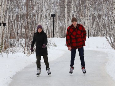 Emmy Kucheran and Everett Smith glide along the skating path at Kivi Park in Sudbury, Ont. on Tuesday January 5, 2021. John Lappa/Sudbury Star/Postmedia Network