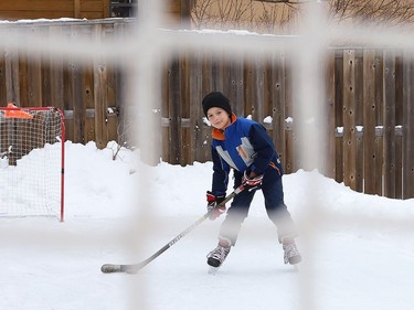 Carter Kuczma, 7, hones his hockey skills on a backyard rink at his home in Sudbury, Ont. on Wednesday January 6, 2021. John Lappa/Sudbury Star/Postmedia Network