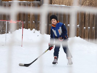 Carter Kuczma, 7, hones his hockey skills on a backyard rink at his home in Sudbury, Ont. on Wednesday January 6, 2021. John Lappa/Sudbury Star/Postmedia Network