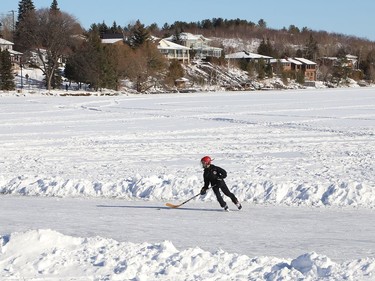 Martin Finn, 11, skates on a cleared section of ice on Ramsey Lake in Sudbury, Ont. on Thursday January 7, 2021.