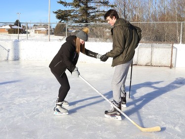 Ann-Marie McNutt learns to skate backwards with the help of Owen Walker at the outdoor rink in Coniston, Ont. on Friday January 8, 2021. John Lappa/Sudbury Star/Postmedia Network