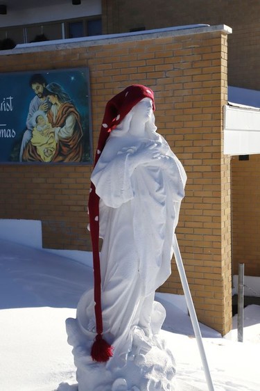 A statue outside St. Paul the Apostle Church in Coniston, Ont. wears a toque on Friday January 8, 2021. John Lappa/Sudbury Star/Postmedia Network