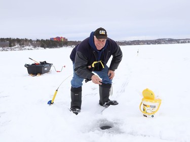 Rolly Rousseau took advantage of the mild temperatures and went ice fishing on Ramsey Lake in Sudbury, Ont. on Tuesday January 12, 2021. John Lappa/Sudbury Star/Postmedia Network