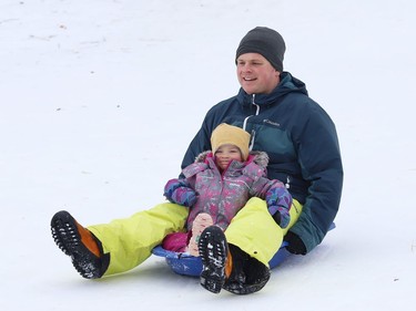 Thierry Middleton goes sliding with his daughter, Lilia, 2, in Sudbury, Ont. on Wednesday January 13, 2021. John Lappa/Sudbury Star/Postmedia Network