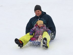 Thierry Middleton goes sliding with his daughter, Lilia, 2, in Sudbury, Ont. on Wednesday January 13, 2021.