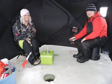Tammy Bazinet and Mike Boisvenue relax while ice fishing in a portable pop up ice hut on Lake Laurentian in Sudbury, Ont. on Thursday January 14, 2021. Under Ontario's stay-at-home orders, outdoor activities are permitted, but with restrictions. John Lappa/Sudbury Star/Postmedia Network