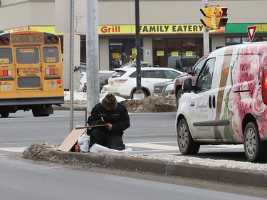 A person panhandles at the intersection of Brady Street and Paris Street in Sudbury, Ont. on Thursday January 14, 2021. John Lappa/Sudbury Star/Postmedia Network