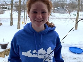 Lily Stewart, a Grade 6 student at Assiginack Public School, proudly displays her new ice fishing rod. Each student at the school received an ice fishing rod in memory of Shan Case.