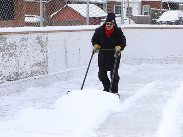 Vic Desormeaux clears snow off the rink at Antwerp Playground in Sudbury, Ont. for flooding on Tuesday January 19, 2021. John Lappa/Sudbury Star/Postmedia Network