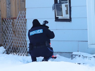 A police officer documents a crime scene on Albert Street in Espanola where the OPP said a shooting occurred on Thursday.
