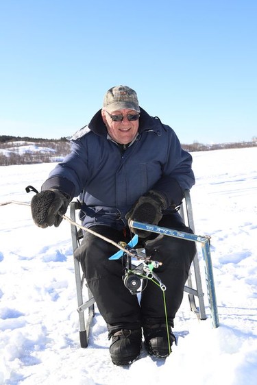 Ernie Dalcourt enjoys the sunshine while ice fishing on Robinson Lake in Sudbury, Ont. on Wednesday January 27, 2021. Dalcourt said he ice fishes on the lake almost every day. John Lappa/Sudbury Star/Postmedia Network