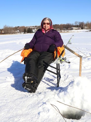 Micheline Denomme enjoys the sunshine while ice fishing on Robinson Lake in Sudbury, Ont. on Wednesday January 27, 2021. John Lappa/Sudbury Star/Postmedia Network