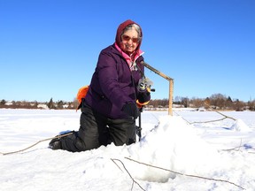 Micheline Denomme enjoys the sunshine while ice fishing on Robinson Lake in Sudbury, Ont. on Wednesday January 27, 2021.