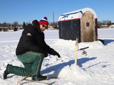 Steph Denomme enjoys the sunshine while ice fishing on Robinson Lake in Sudbury, Ont. on Wednesday January 27, 2021. John Lappa/Sudbury Star/Postmedia Network