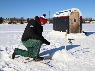 Steph Denomme enjoys the sunshine while ice fishing on Robinson Lake in Sudbury, Ont. on Wednesday January 27, 2021. John Lappa/Sudbury Star/Postmedia Network