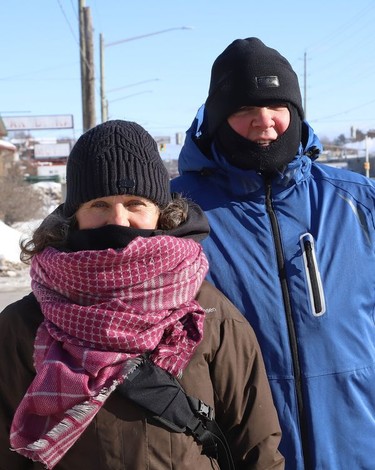 Liza and Larry Stewart bundled up to keep warm while going for a walk in Sudbury, Ont. on Thursday January 28, 2021. Environment Canada said Greater Sudbury can expect more frigid temperatures Friday with a high of -13 C and a wind chill of -31 C in the morning and -19 C in the afternoon. John Lappa/Sudbury Star/Postmedia Network