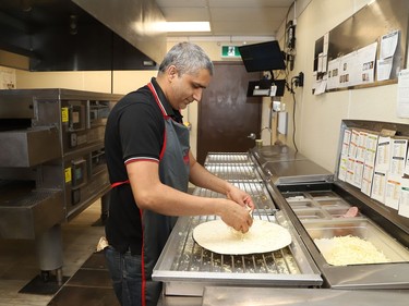 Muhammad Afzal, franchise owner of Papa Murphy's Pizza at 499 Notre Dame Ave. in Sudbury, Ont., prepares a pizza order on Thursday January 28, 2021. John Lappa/Sudbury Star/Postmedia Network