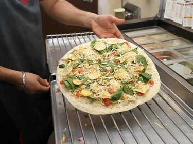 Jaspreet Singh, general manager of Papa Murphy's Pizza at 499 Notre Dame Ave. in Sudbury, Ont., displays the ingredients for a pizza order on Thursday January 28, 2021. John Lappa/Sudbury Star/Postmedia Network