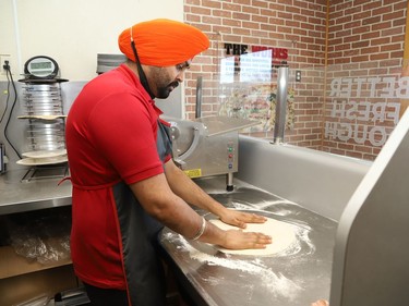 Jaspreet Singh, general manager of Papa Murphy's Pizza at 499 Notre Dame Ave. in Sudbury, Ont., prepares the dough for a pizza order on Thursday January 28, 2021. John Lappa/Sudbury Star/Postmedia Network