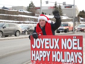 Nickel Belt MP Marc Serre waves to motorists at the south end as part of his holiday greetings to community members in Greater Sudbury, Ont. on Wednesday December 16, 2020.