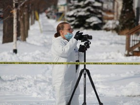 A member of the Sarnia Police Service is shown outside a house on Devine Street on Jan. 27 where police are investigating a possible homicide. It was the city's fourth homicide investigation in January. Paul Morden/Postmedia Network