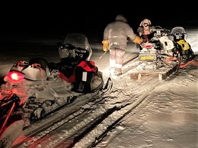 Master Cpl. Mike Koostachin and Cpl. Maurice Mack load a stranded Peawanuck snowmobiler's broken-down machine onto a toboggan after going to his aid.

Supplied/Master Cpl. Jason Hunt
