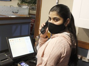 Sandeep Kaur, one of the staff members at the Siva's Family Restaurant, takes an online food order as most local restaurants are adapting to survive the COVID-19 pandemic while continuing to offer take-out, curbside and delivery services only during these times.

RICHA BHOSALE/The Daily Press