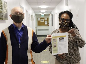 Stan Cor, executive director at the Good Samaritan Inn, and Agnes Okonmah, office manager at the Inn, showing a flyer with all the details about the services they provide at the new location. 

RICHA BHOSALE/The Daily Press